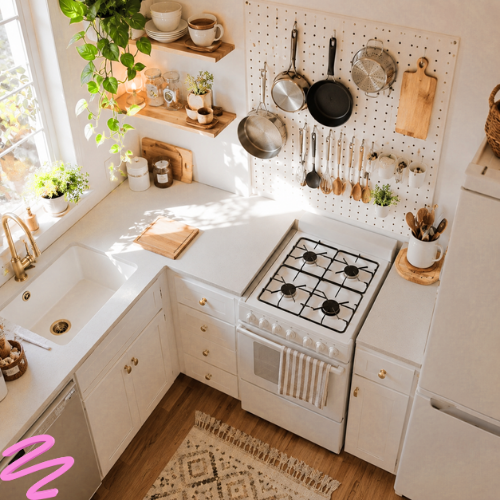Small white kitchen with a mounted pegboard wall organizer holding pots | kitchen organization ideas