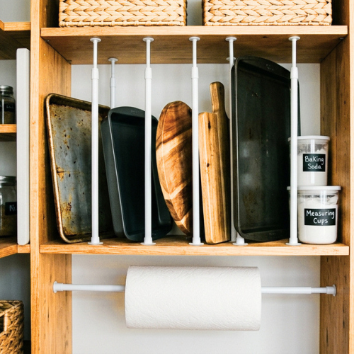 Tension rods used vertically on a pantry shelf to separate baking sheets
